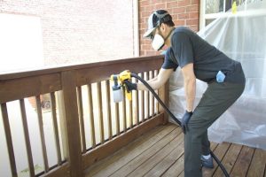 Glendale House Painting worker painting a fenced rail