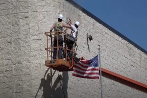 Glendale commercial painting workers on a lift painting a wall